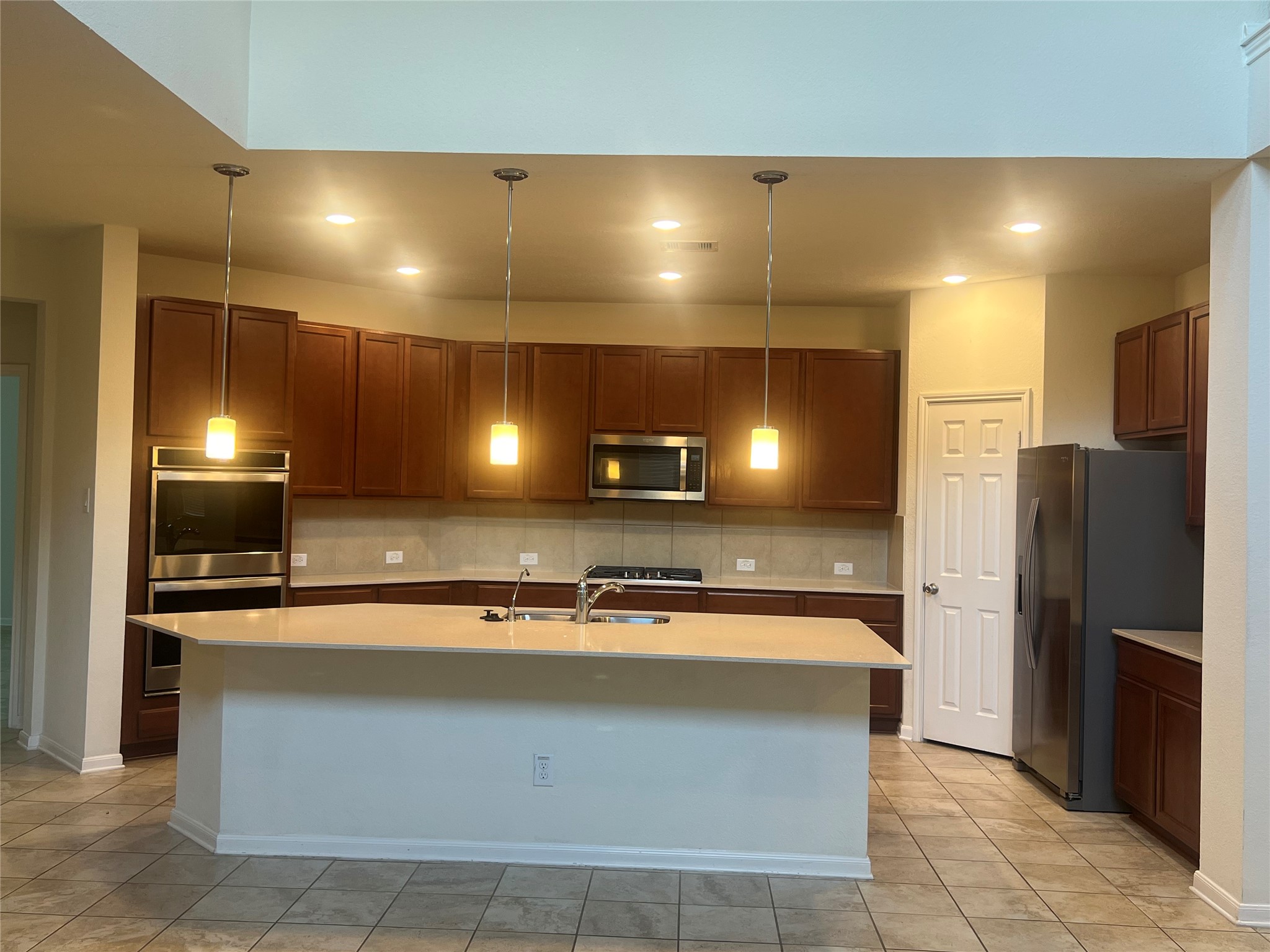14112 Harmony Ridge Trail Pearland, TX 77584 - Photo 17 of 45 a large kitchen with a sink stainless steel appliances and cabinets