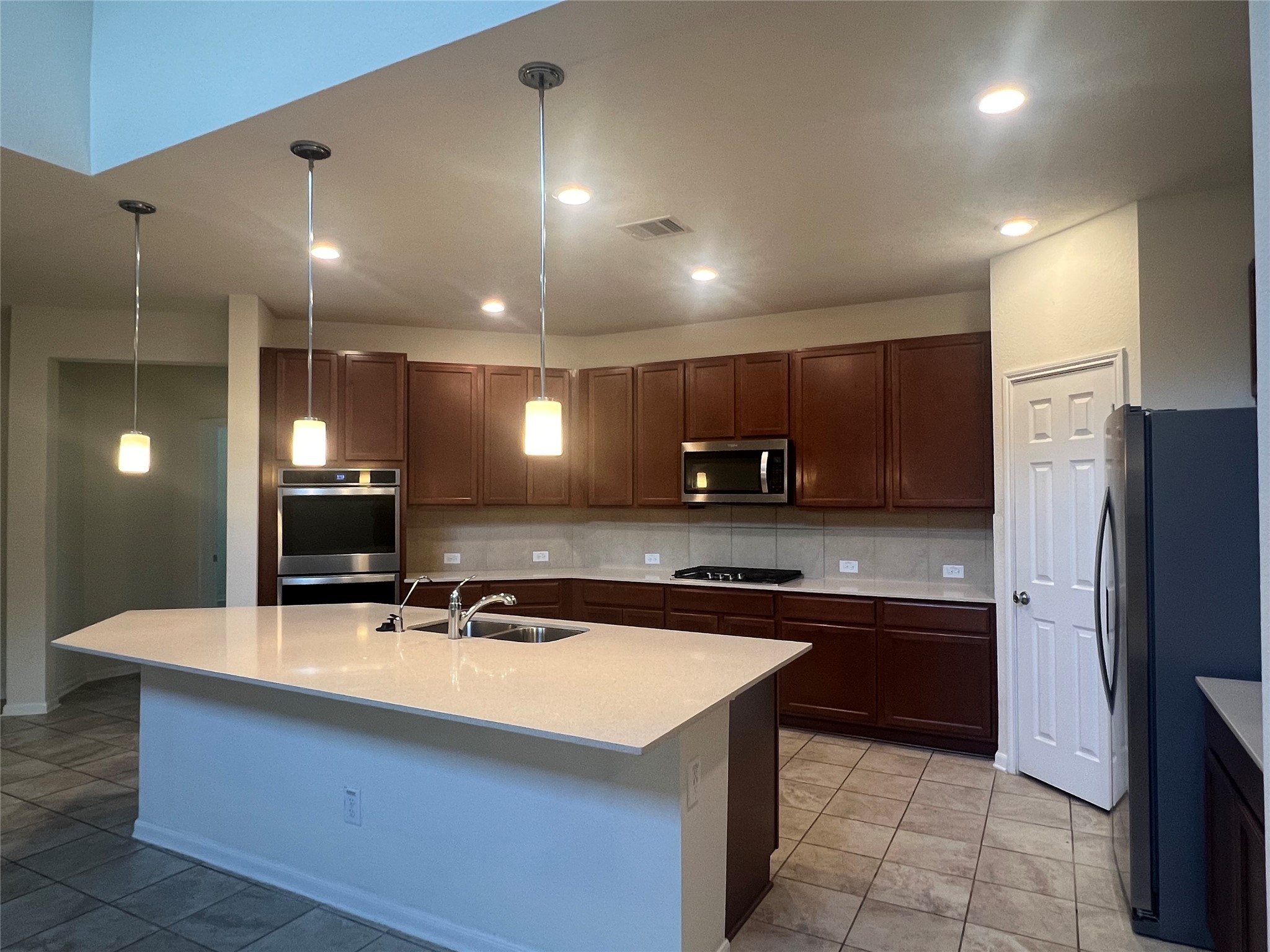 14112 Harmony Ridge Trail Pearland, TX 77584 - Photo 18 of 45 a kitchen with stainless steel appliances a sink stove and refrigerator