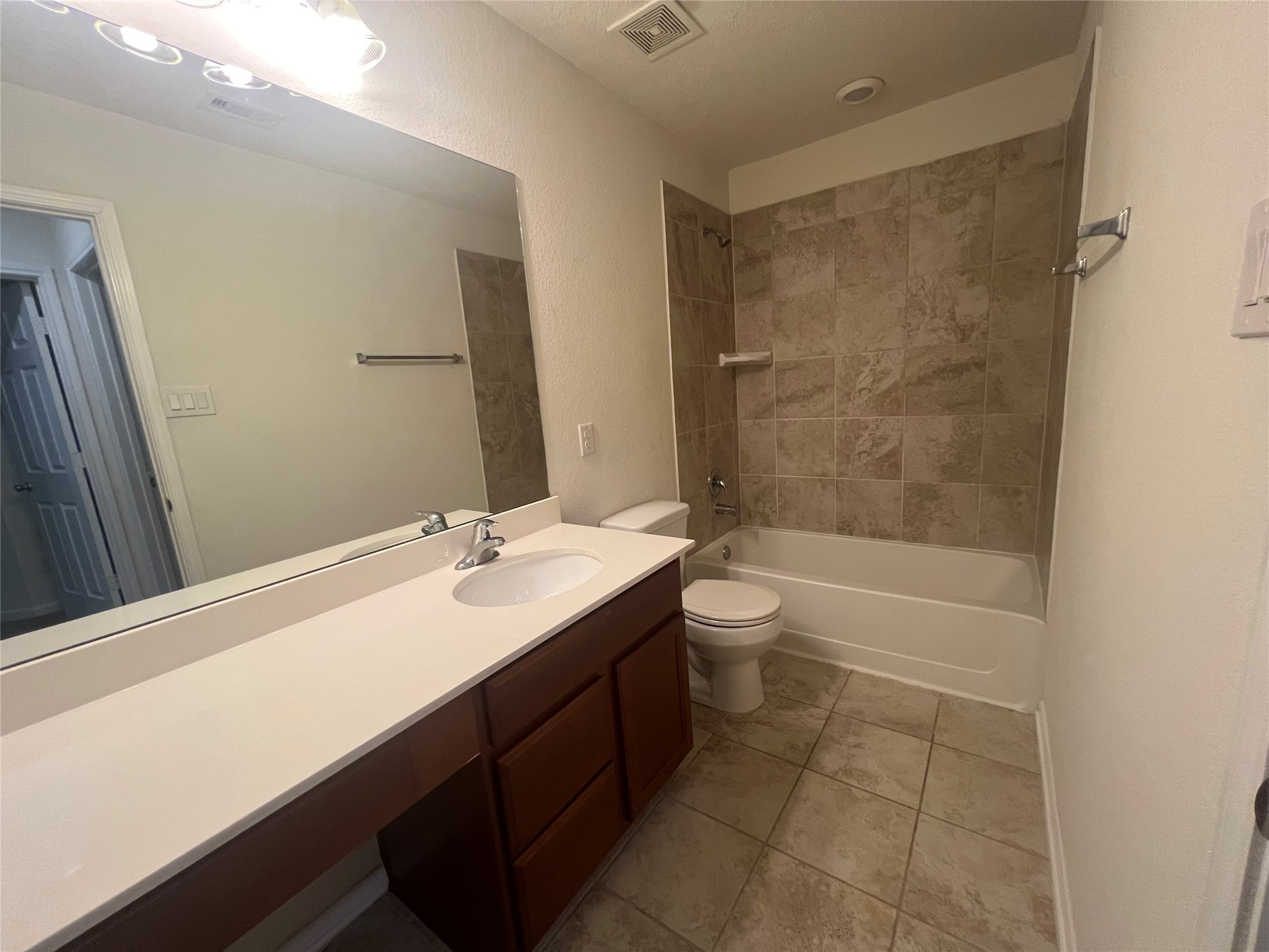 14112 Harmony Ridge Trail Pearland, TX 77584 - Photo 25 of 45 a bathroom with a granite countertop sink a toilet and bathtub