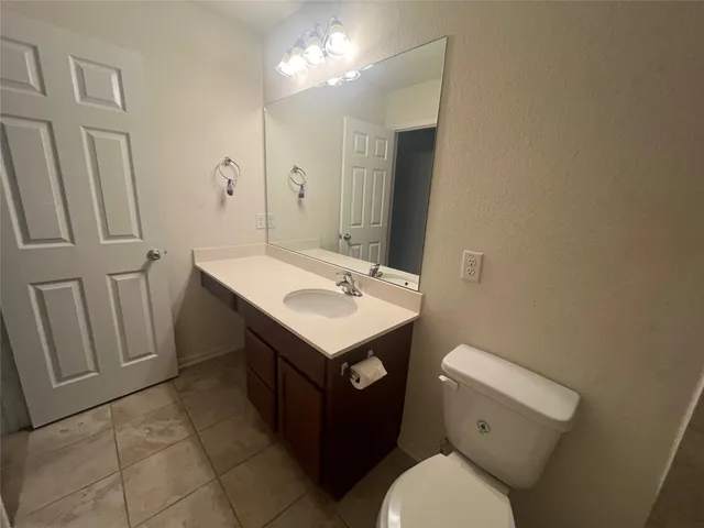 a bathroom with a sink toilet vanity and a mirror