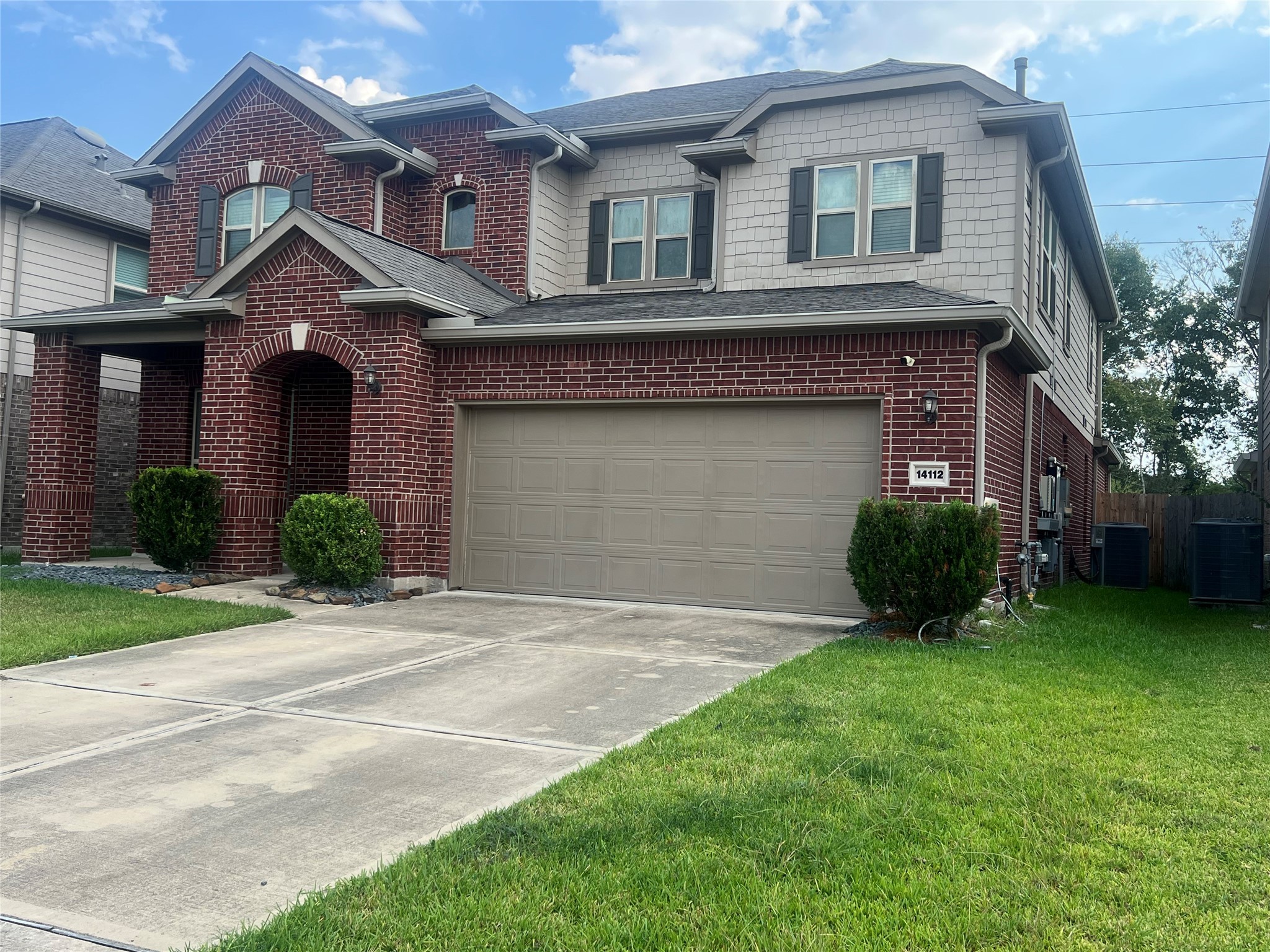 14112 Harmony Ridge Trail Pearland, TX 77584 - Photo 4 of 45 a front view of a house with a yard and garage