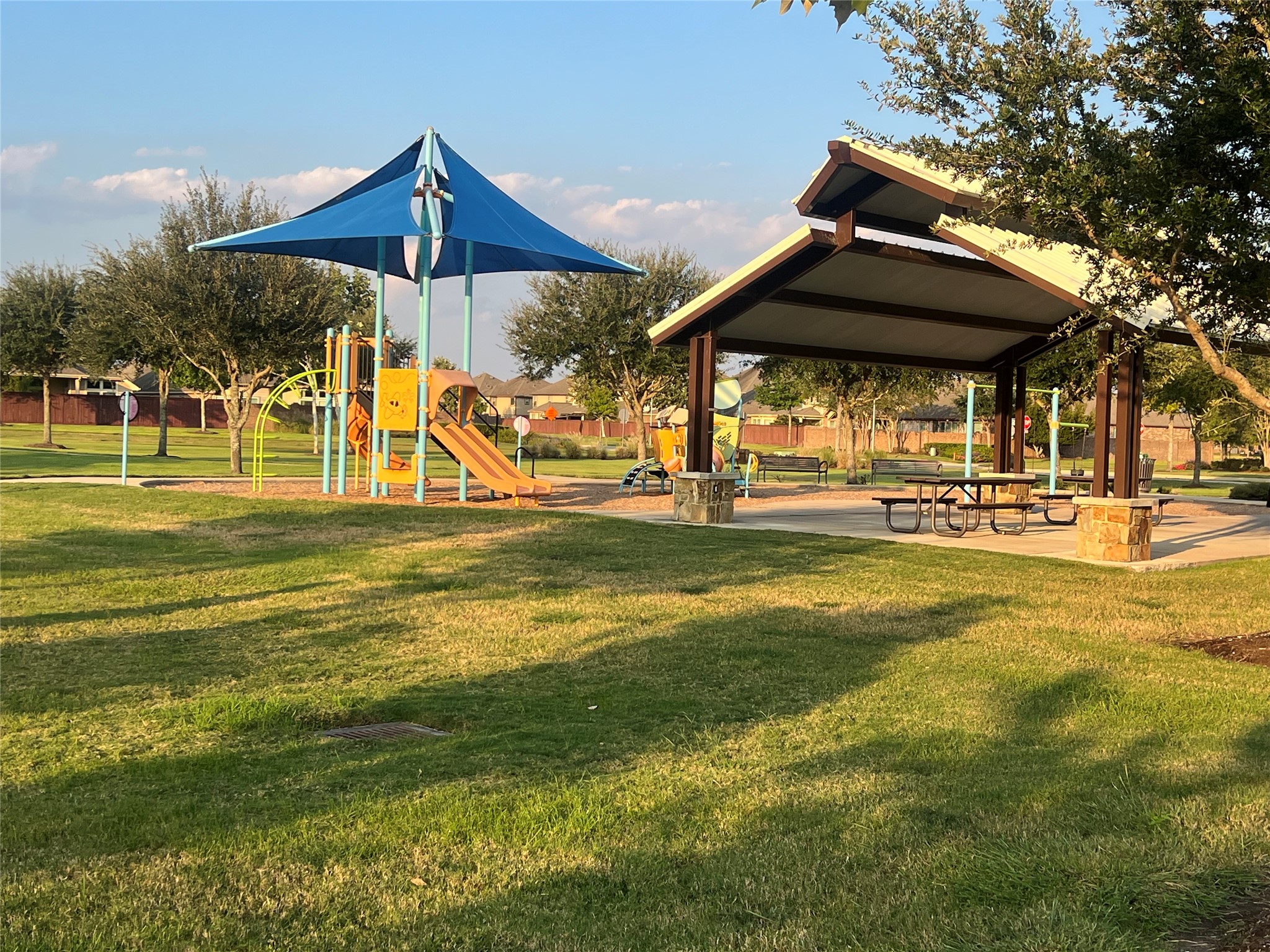 14112 Harmony Ridge Trail Pearland, TX 77584 - Photo 43 of 45 a view of a swimming pool with a table and chairs under an umbrella