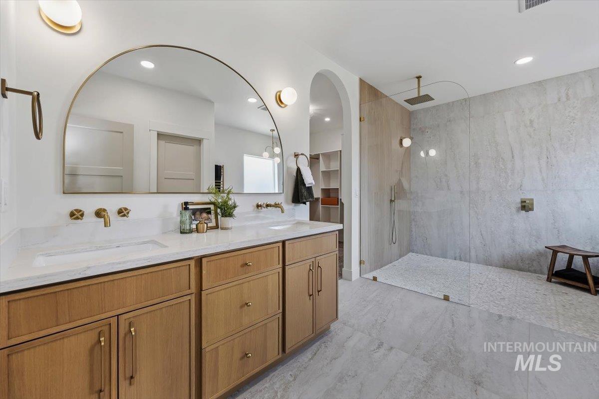 2005 Sparrow Street Rupert, ID 83350 - Photo 16 of 30 Dual vanity with wood-finish cabinetry, integrated sinks, and brass-finish wall-mounted faucets