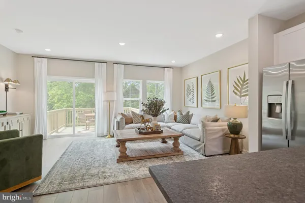 a living room with furniture and large windows