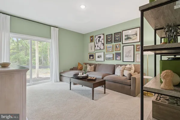 a living room with furniture and a floor to ceiling window