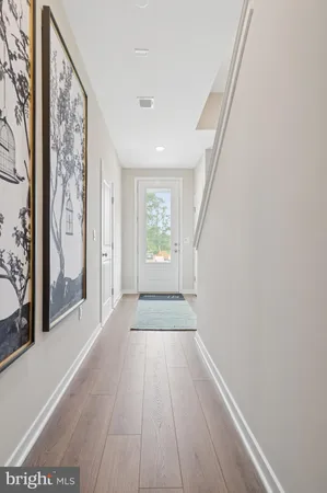 a view of a hallway with wooden floor and a fireplace