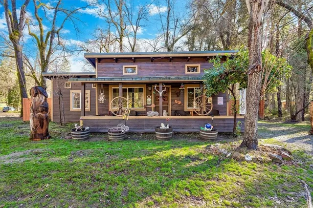 a view of a house with a yard and sitting area