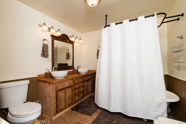 a bathroom with a sink vanity mirror and toilet