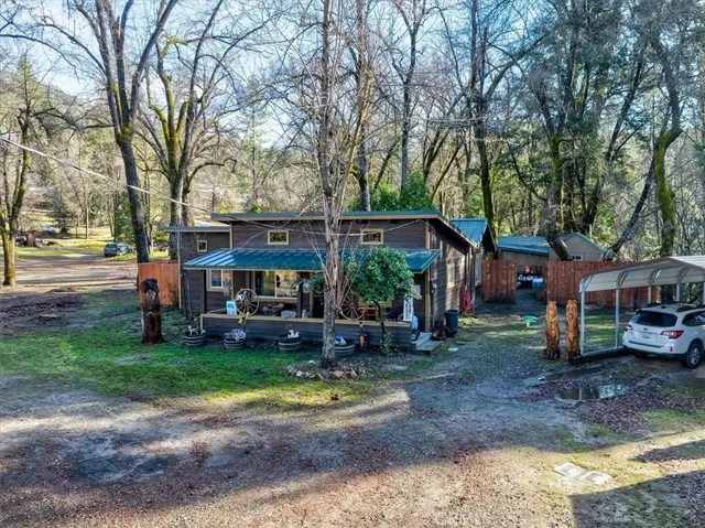 a view of a yard with a house and large trees