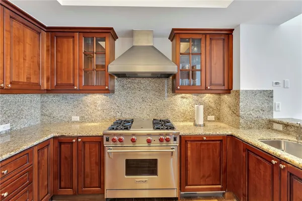 a bathroom with a tub a sink and a large mirror