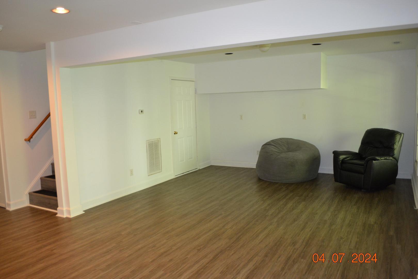 4506 Mistiflower Drive Raleigh, NC 27606 - Photo 20 of 27 a view of an empty room and wooden floor