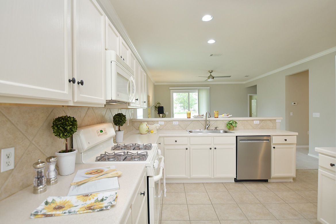 203 Winter Drive Georgetown, TX 78633 - Photo 7 of 29 White cabinets contribute to making the kitchen light and bright.