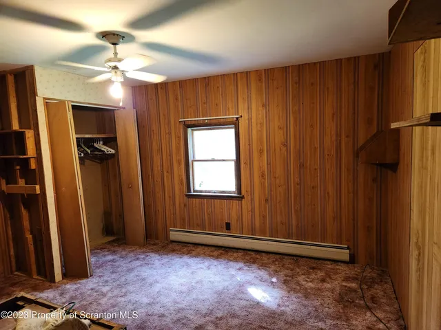 a view of an empty room and a window