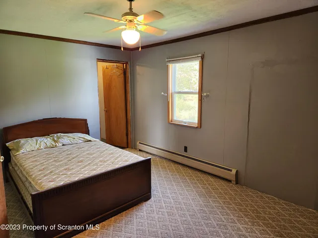 a bedroom with a bed and a window
