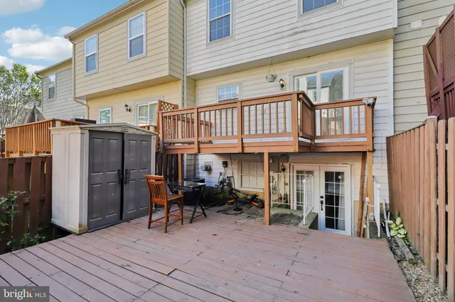a view of a dinning table and chairs in patio of the house