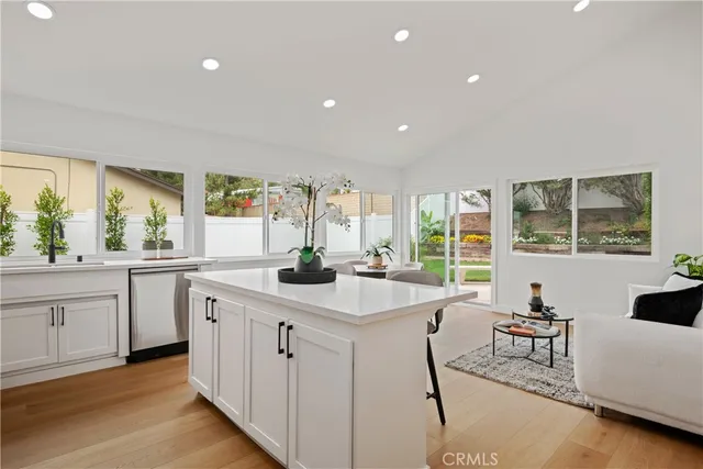 a kitchen with sink attached with living room