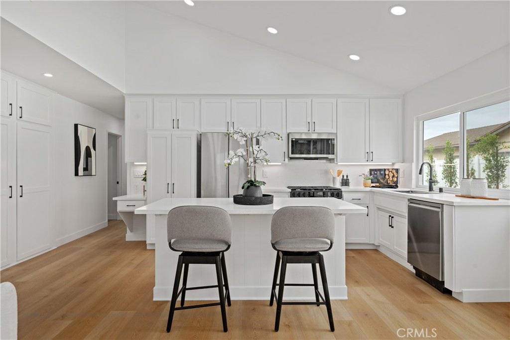 2108 Ardenwood Avenue Simi Valley, CA 93063 - Photo 15 of 33 a kitchen with stainless steel appliances granite countertop a white cabinets and wooden floor