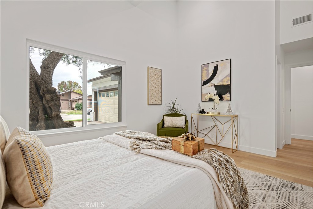 2108 Ardenwood Avenue Simi Valley, CA 93063 - Photo 21 of 33 a bedroom with a bed and wooden floor