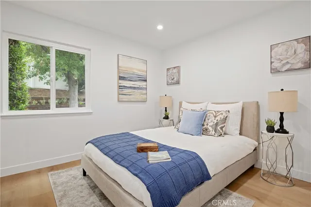 a bedroom with a large bed and a window