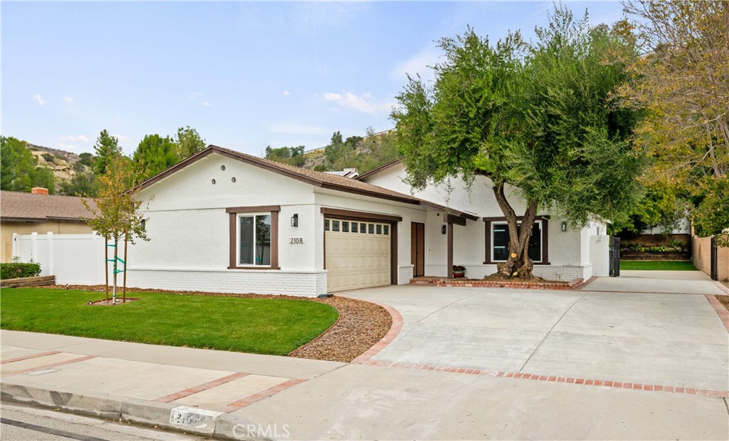 2108 Ardenwood Avenue Simi Valley, CA 93063 - Photo 6 of 33 a front view of a house with a yard and garage