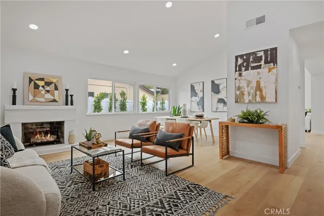 a living room with furniture a fireplace and a table