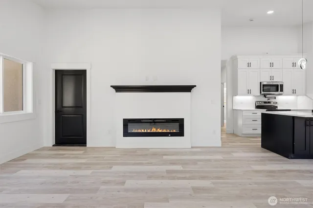 a view of a kitchen with a sink and dishwasher a refrigerator with wooden floor