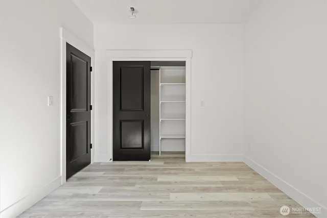 a backyard of a house with large trees and plants