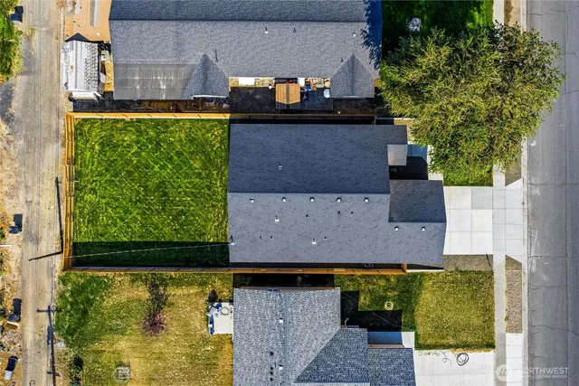 a aerial view of a house with a garden and a yard