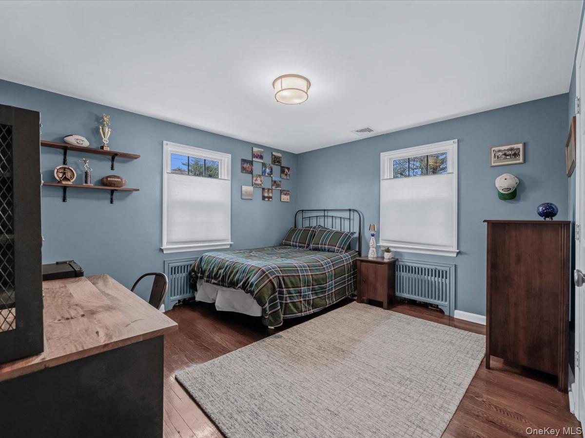 1896 Russell Street Bellmore, NY 11710 - Photo 11 of 21 a bedroom with a bed and wooden floor