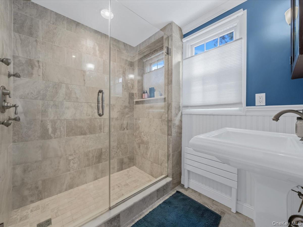 1896 Russell Street Bellmore, NY 11710 - Photo 16 of 21 a bathroom with a shower and a sink