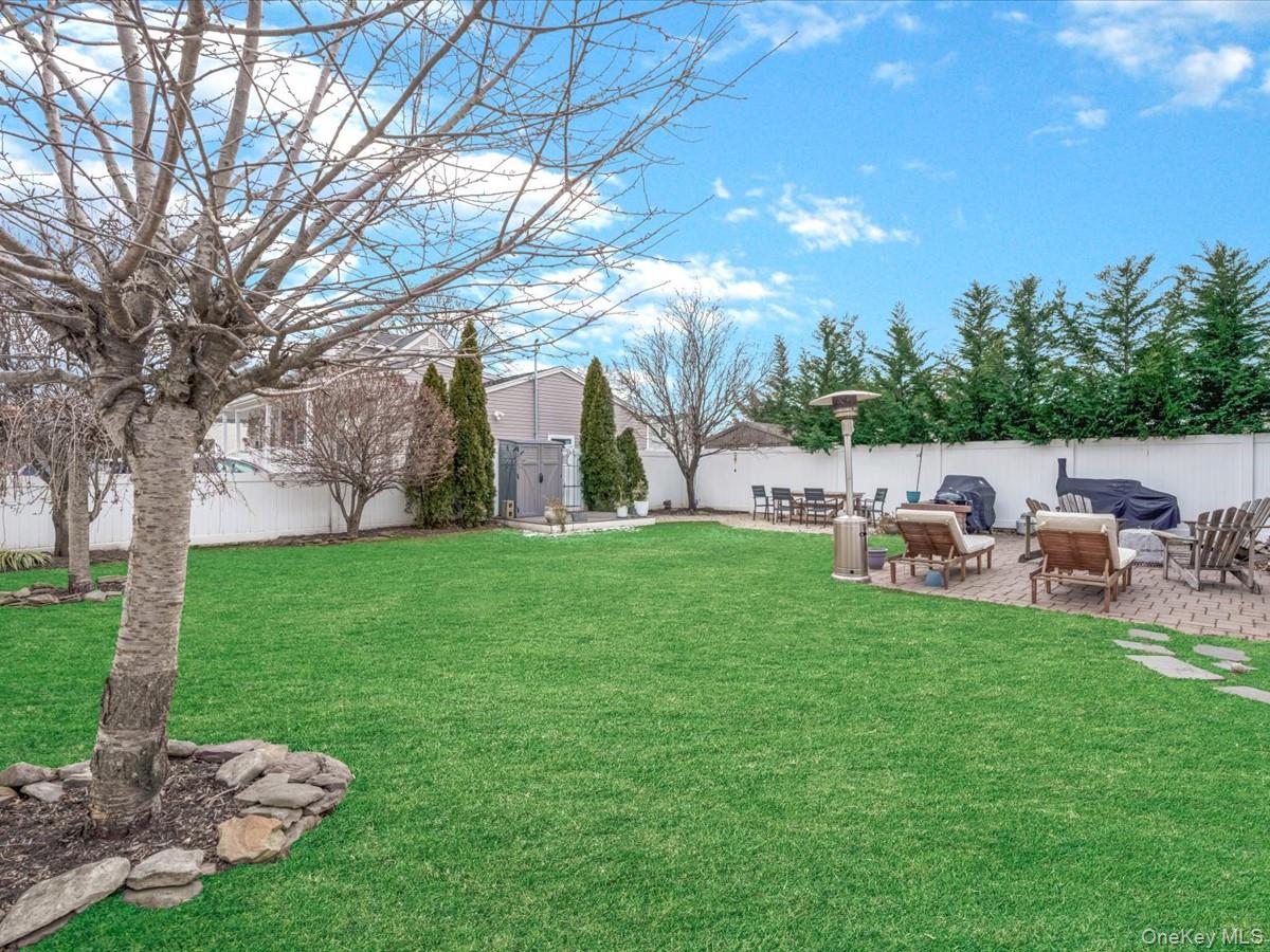 1896 Russell Street Bellmore, NY 11710 - Photo 20 of 21 a backyard of a house with table and chairs