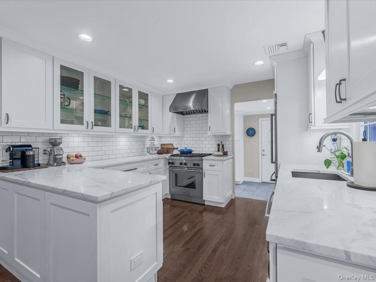 1896 Russell Street Bellmore, NY 11710 - Photo 3 of 21 a kitchen with a sink stove and cabinets