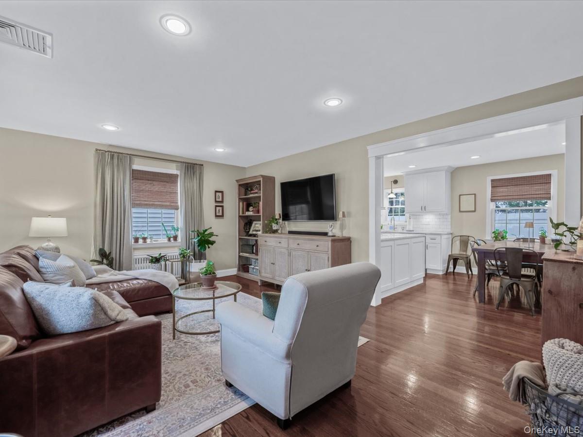 1896 Russell Street Bellmore, NY 11710 - Photo 5 of 21 a living room with furniture flat screen tv and wooden floor