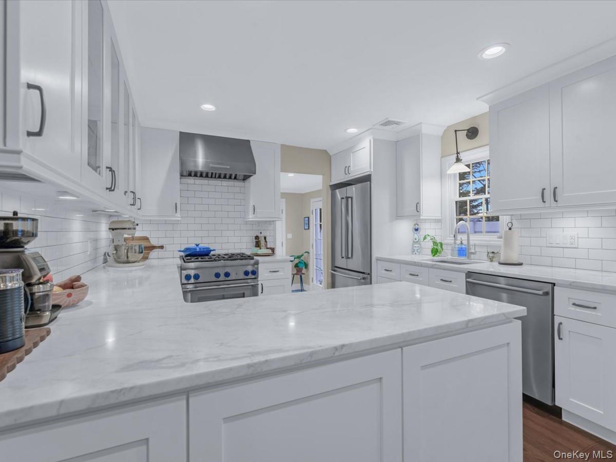 1896 Russell Street Bellmore, NY 11710 - Photo 8 of 21 a kitchen with stainless steel appliances a sink a stove and cabinets