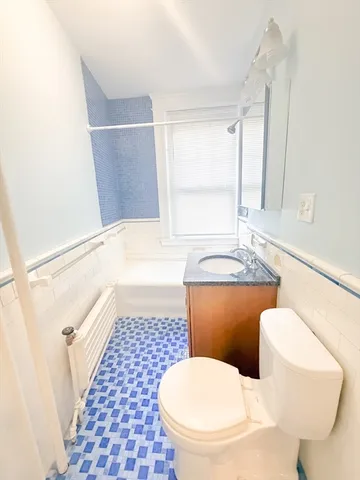 a bathroom with a toilet a sink and a shower