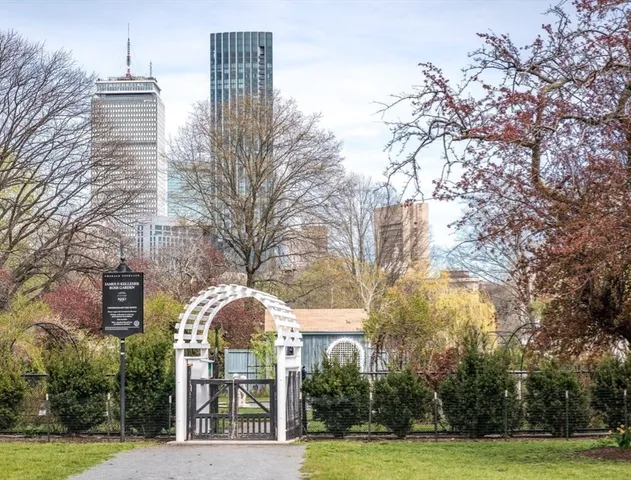 a view of a large building with a tree and garden