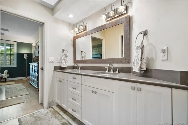 a bathroom with double sink and a mirror