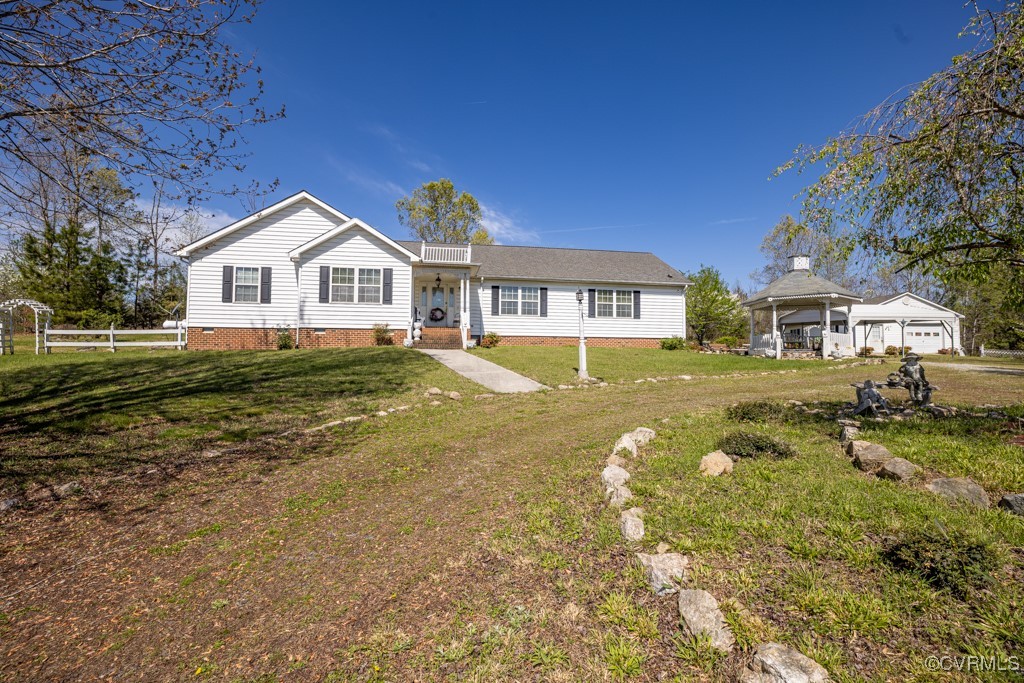 a view of a house with a big yard and large trees