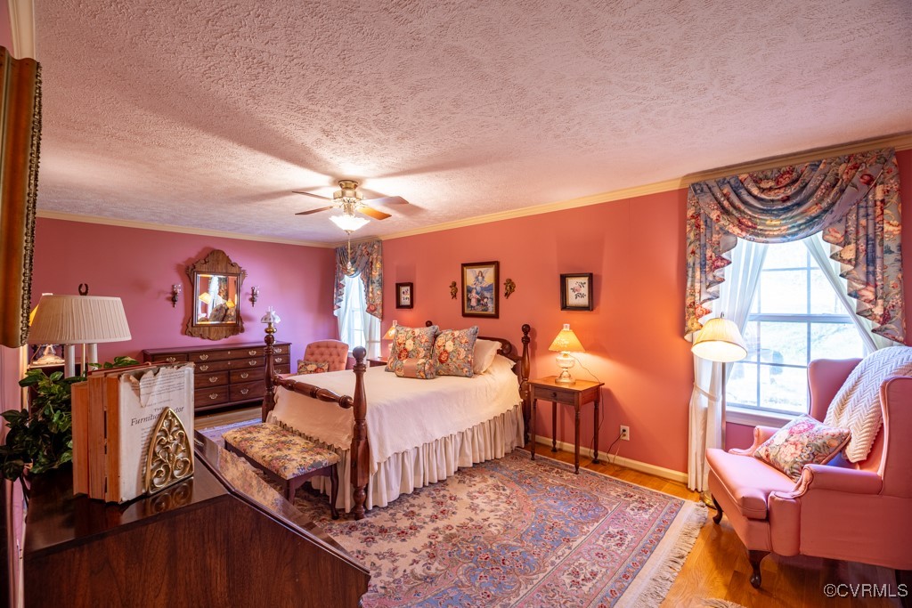 1416 Snead Spring Road Crewe, VA 23930 - Photo 20 of 35 a bedroom with furniture and a chandelier