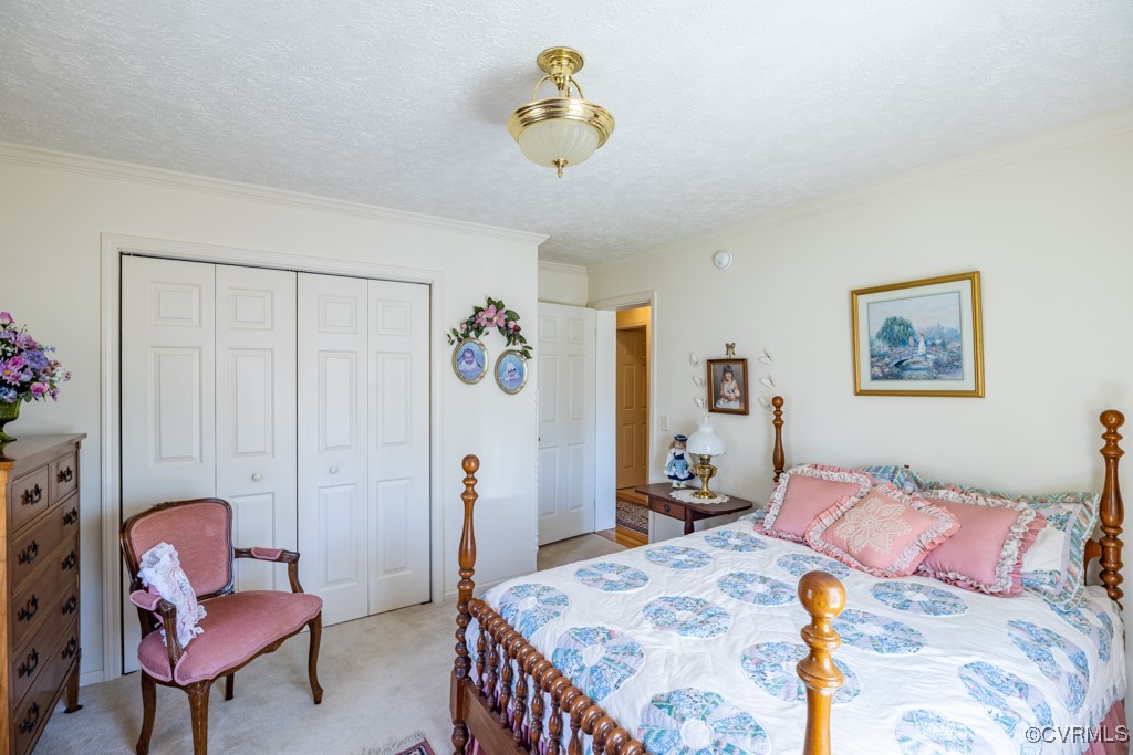 1416 Snead Spring Road Crewe, VA 23930 - Photo 27 of 35 a bedroom with a bed and a chandelier