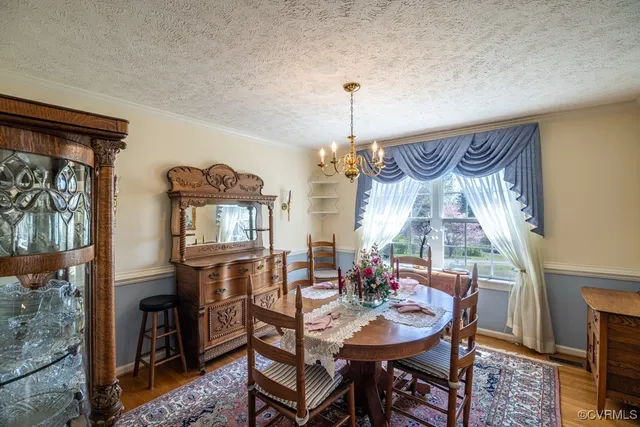 a kitchen with a table chairs refrigerator and cabinets