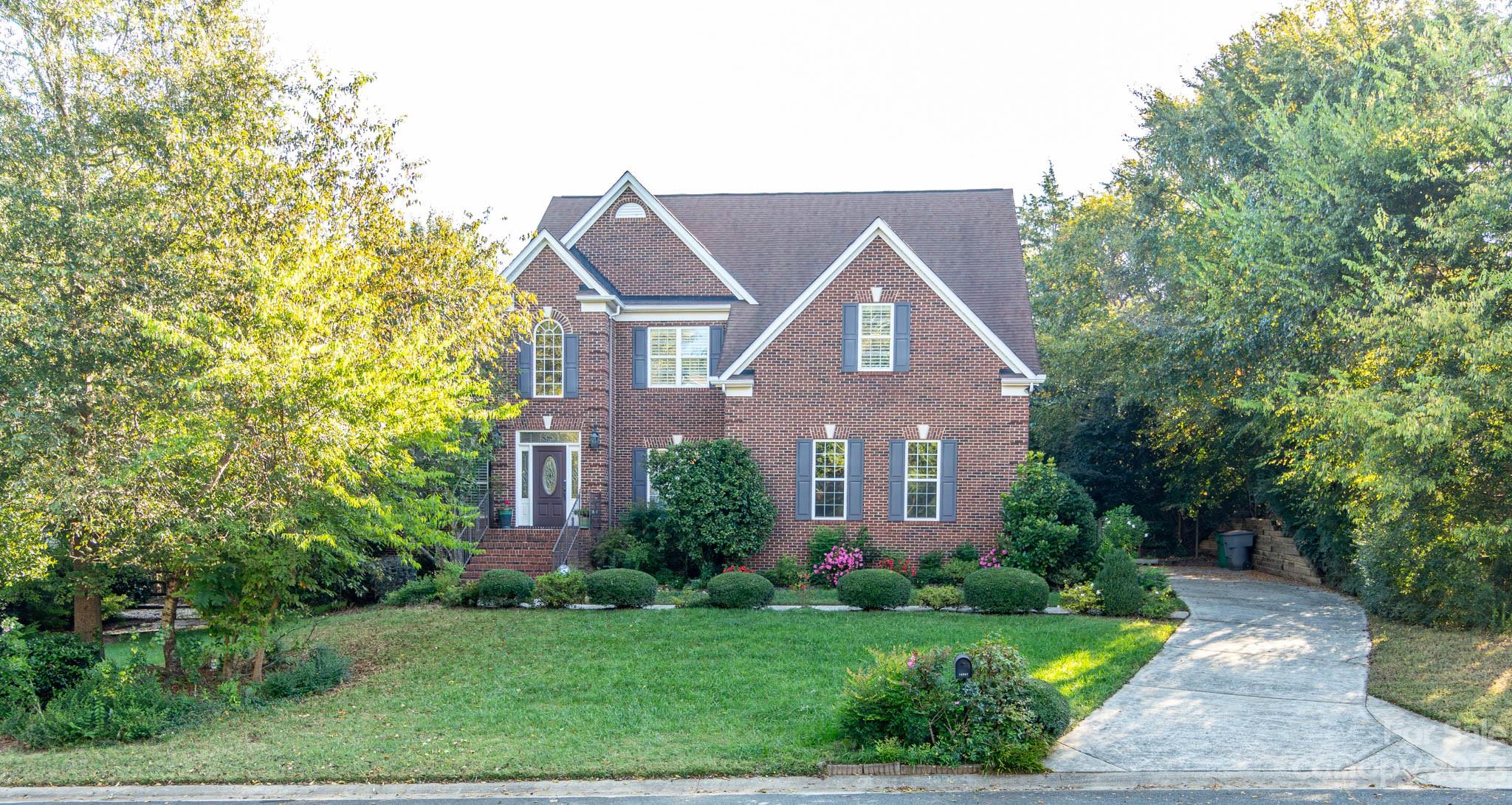 10507 Rougemont Lane Charlotte, NC 28277 - Photo 1 of 48 a front view of a house with a yard and trees