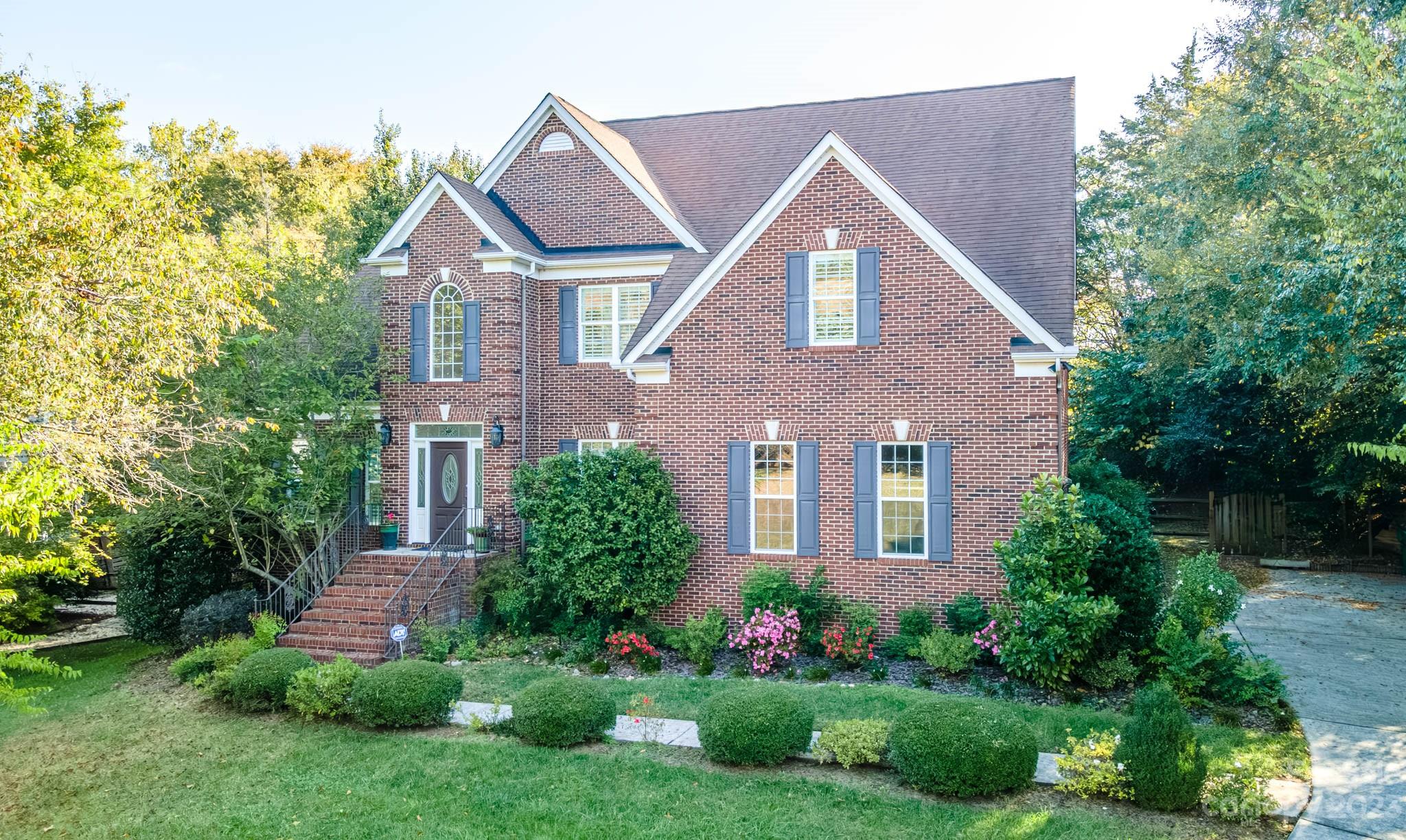 10507 Rougemont Lane Charlotte, NC 28277 - Photo 2 of 48 a front view of a house with a garden