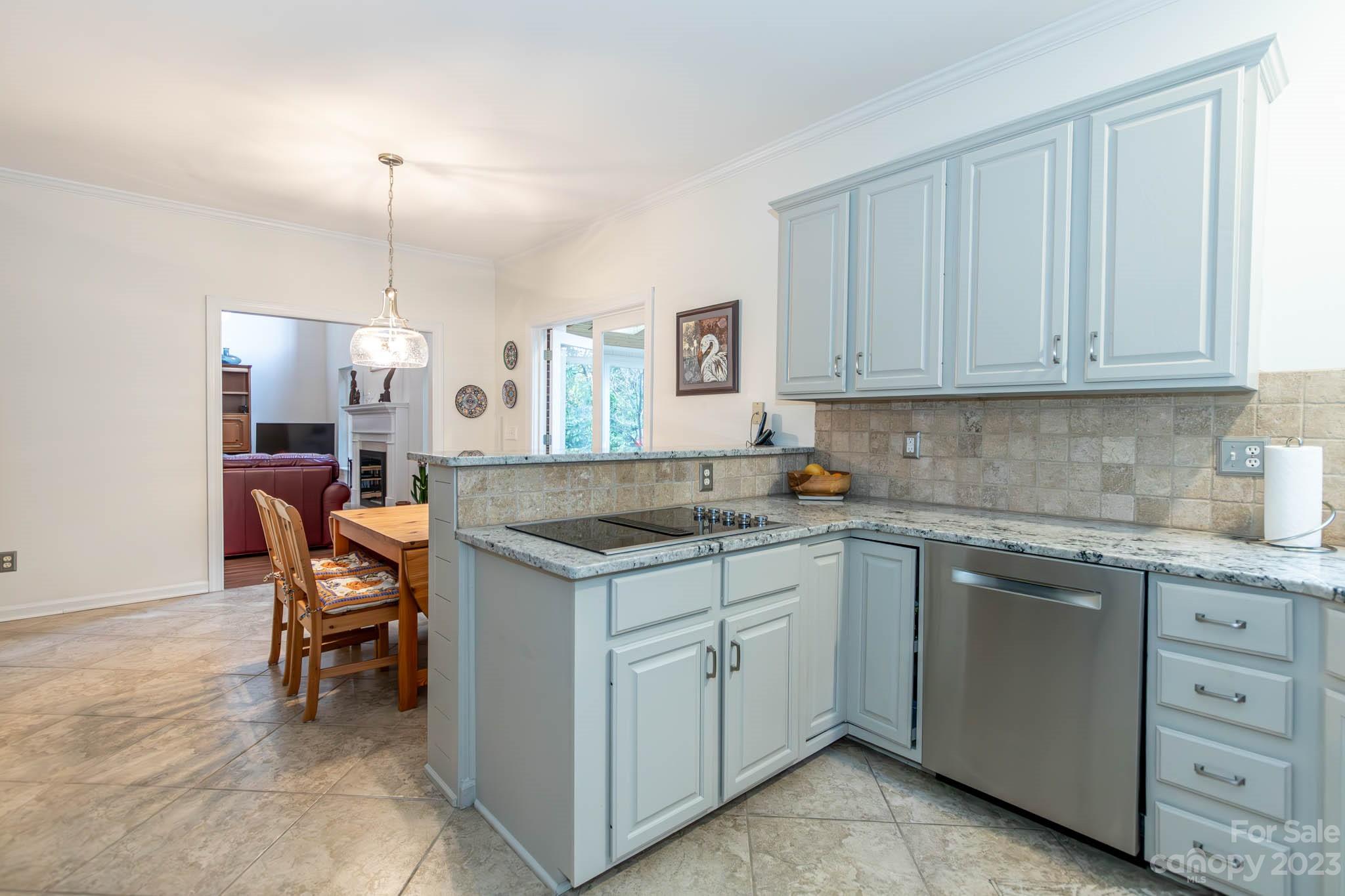 10507 Rougemont Lane Charlotte, NC 28277 - Photo 24 of 48 a kitchen with a sink a stove a table and chairs