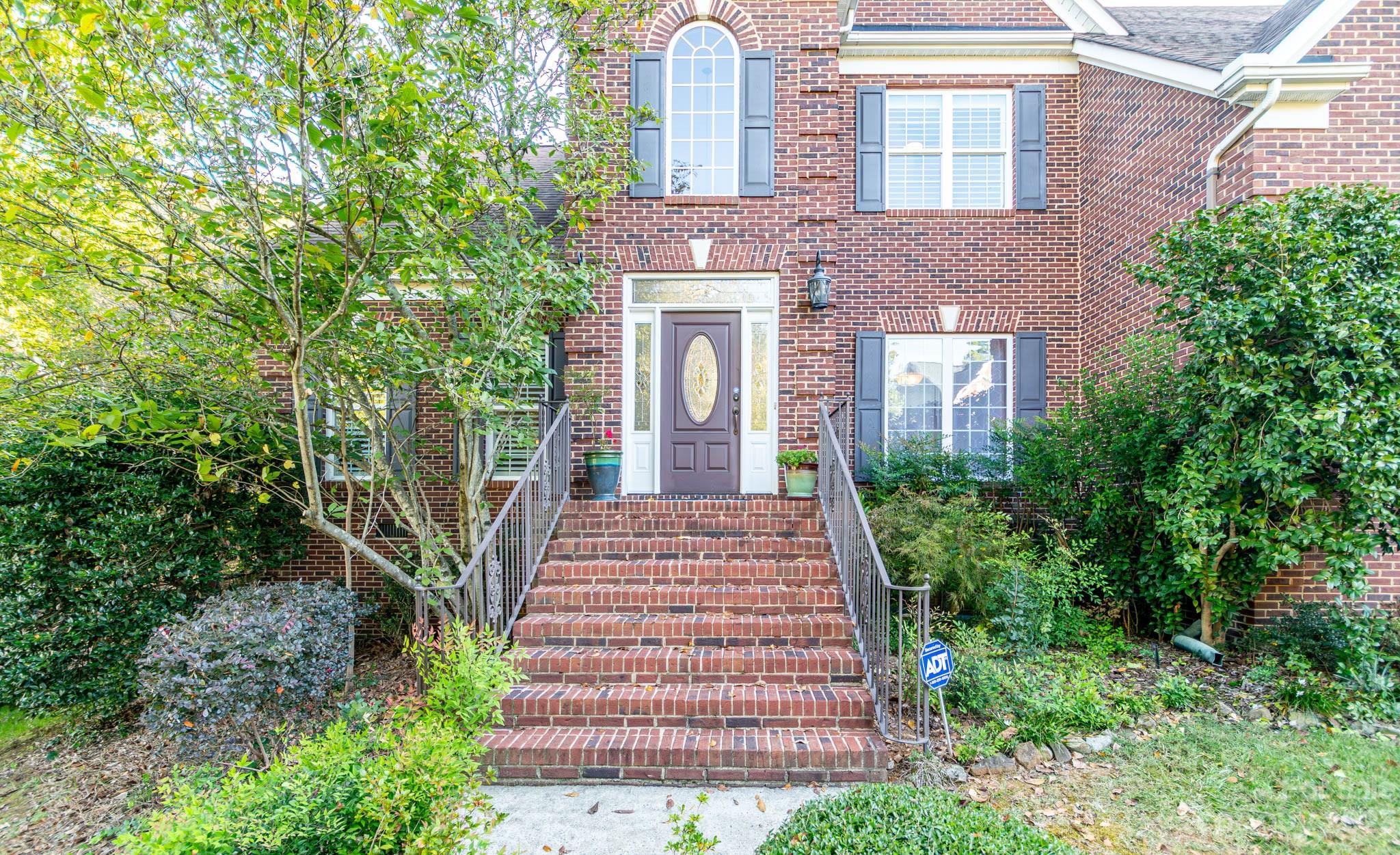 10507 Rougemont Lane Charlotte, NC 28277 - Photo 3 of 48 a front view of a house with a garden