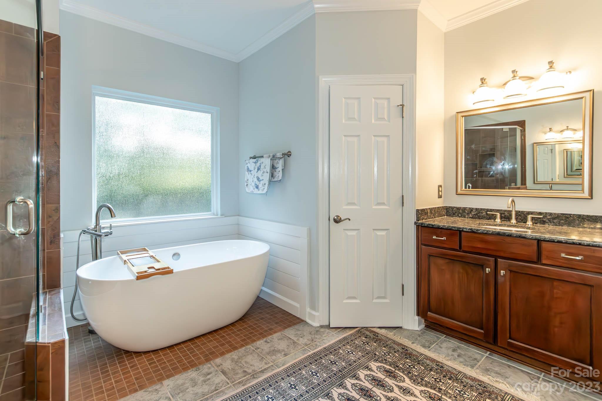 10507 Rougemont Lane Charlotte, NC 28277 - Photo 32 of 48 a spacious bathroom with a tub sink and mirror