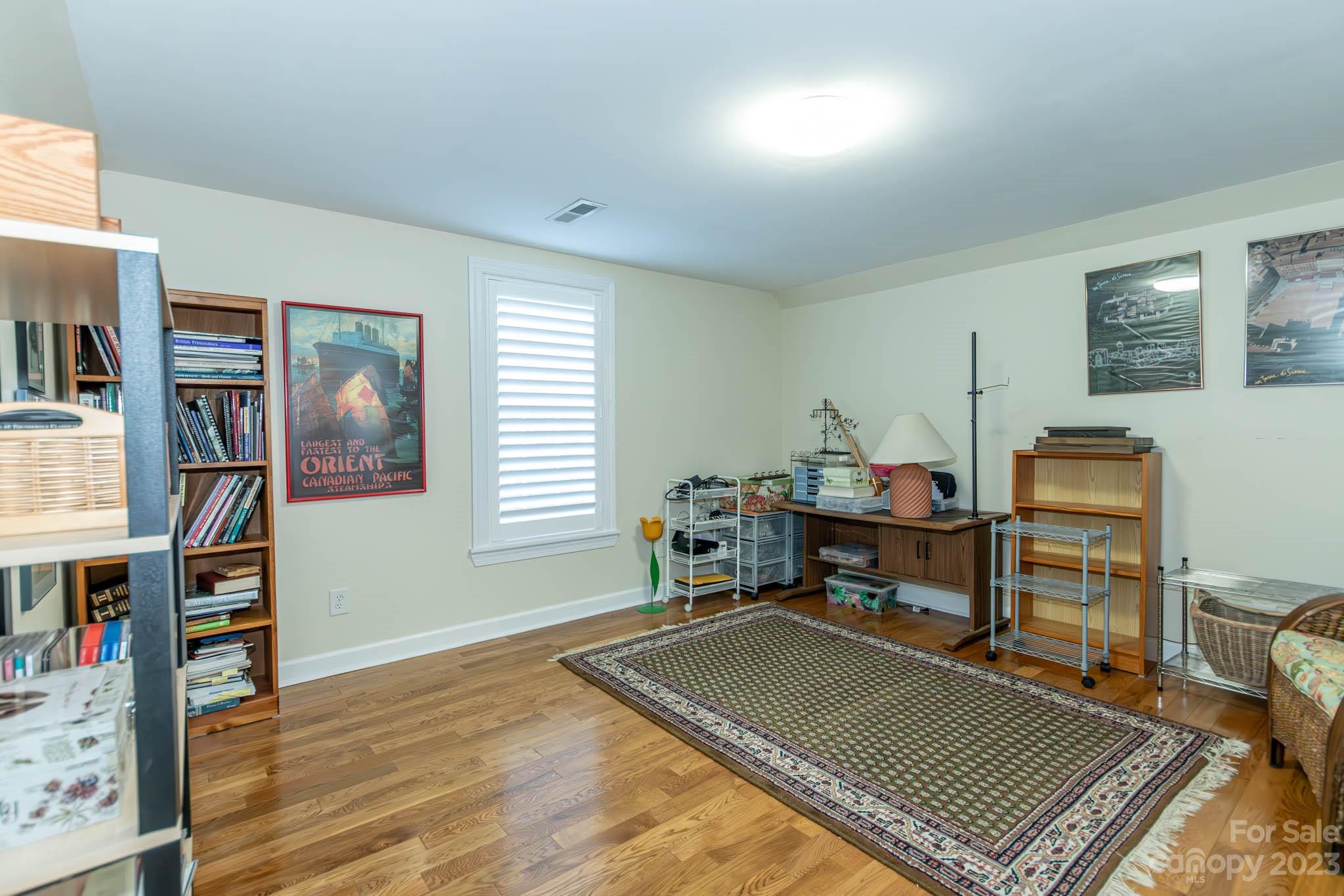 10507 Rougemont Lane Charlotte, NC 28277 - Photo 38 of 48 a work room with furniture a bookshelf and a window