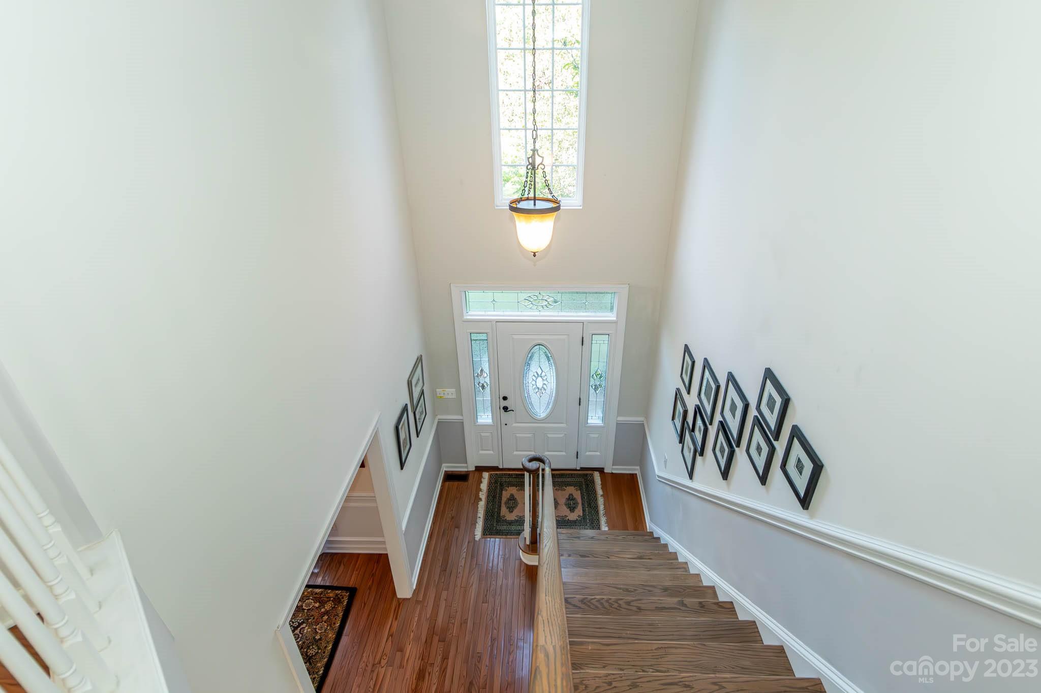 10507 Rougemont Lane Charlotte, NC 28277 - Photo 48 of 48 a view of a hallway to a livingroom with wooden floor and stairs