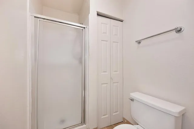 a bathroom with a shower and a toilet