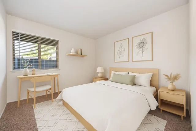 a bedroom with a bed and a desk